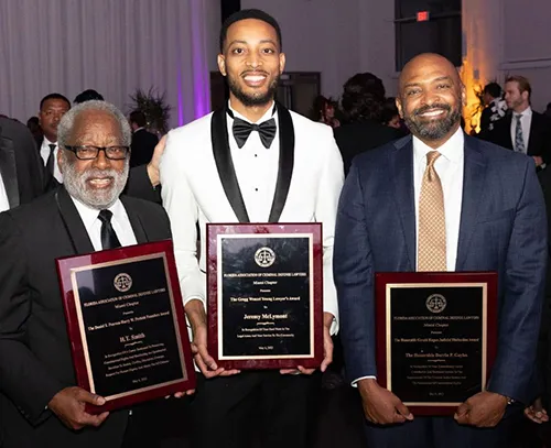 From left to right: H.T. Smith, Jeremy McLymont, Federal Judge Darrin Gayles.